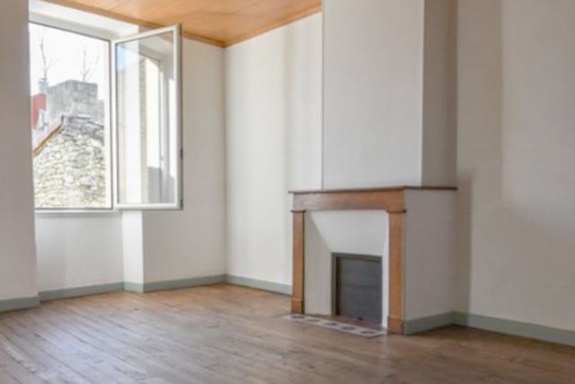 Chambre vide, cheminée de pierre nue